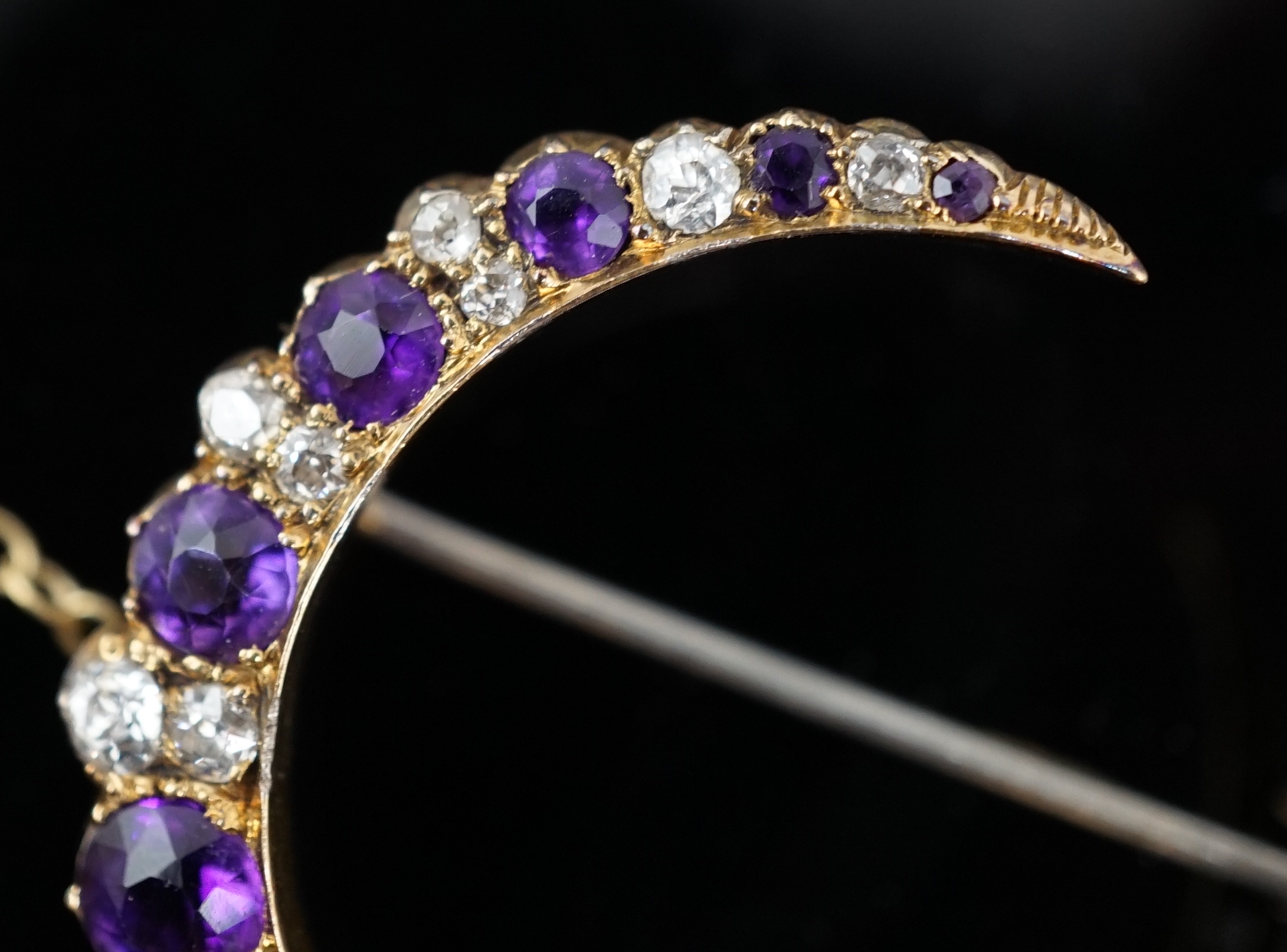 A late Victorian gold, graduated amethyst and diamond cluster set crescent brooch